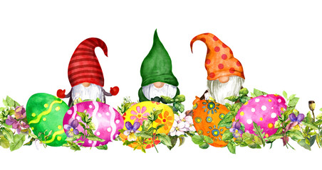 Decorated Easter eggs, scandinavian gnomes in floral seamless border with green grass and spring flowers. Watercolor for holiday card