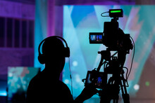 Cameraman Silhouette. Professional Cameraman - Covering On Event With A Video, Cameraman Silhouette On Live Studio News. Television Live Streaming