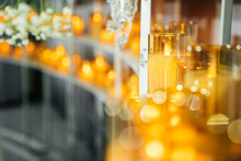 Electric Candle In Glass In A Decorative Decoration Of A Wedding Hall. Warm Atmosphere With Soft Blur And Focus On The Candle.