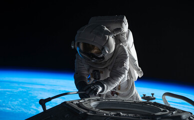 female astronaut performing spacewalk, working on a outer part of a space craft