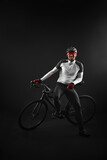 Fototapeta Do przedpokoju - male cyclist with road bicycle on black background