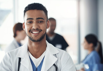 Poster - I gave up my life to learn how to save yours. Shot of a young male doctor standing in the office of a hospital.