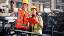Engineer Wearing Safety Vest Controlling Machine Working Talking With Assistant Engineer Worker Checking Safety First For Labour Workers. Safety Officer Check Machine In Factory.