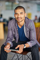Aufkleber - i use it for work and entertainment. portrait of a handsome young man using a digital tablet in an o