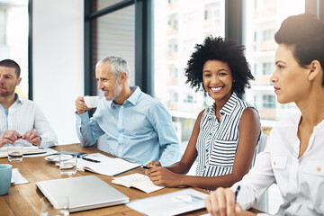 Sticker - This meeting is in full swing. Portrait of a young businesswoman sitting in a meeting with her colleagues.