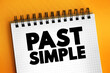 Past simple - basic form of the past tense in Modern English, text concept on notepad