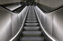 Long And Steep Underground Escalator Rolling Upwards.