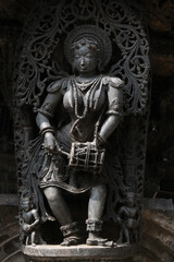  Stone Sculpture of Beautiful Female (Madanikas) with selective focus, 12th century Hindu temple, Ancient stone art and sculptures in each pillars, Chennakeshava Temple, Belur, Karnataka, India.