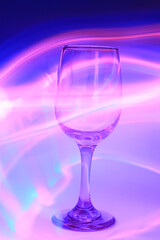 Poster - Closeup shot of a wine glass with blue abstract light, light painting