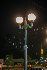 Sticker - Vertical shot of a lantern near the street on the blurry background in Mumbai, India