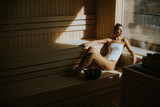 Young woman relaxing in the sauna