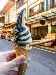 Wall Mural - Close-up shot of a male hand holding an ice cream in Taiwan