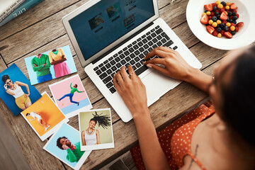 Poster - Getting some blog inspiration. High angle shot of an unrecognizable businesswoman sitting in her home office and blogging from her laptop.