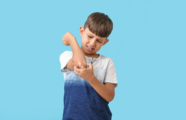 Wall Mural - Little boy scratching himself on color background