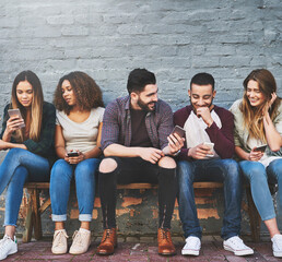 Poster - whats life without friends and wifi. shot of a group of young friends using their mobile phones outd