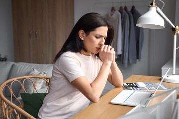 Sticker - Worried woman with laptop sitting at table