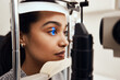 © N Felix/peopleimages.com - Keep as still as possible. Shot of a young woman getting her eyes examined with a slit lamp.