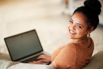 Poster - I wonder what social media has in store for me. Shot of a beautiful young woman using a laptop at home.