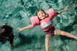 © Maria Manco/Stocksy - little girl floating on back in swimming pool