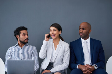 Aufkleber - This call might reveal who got the job. Studio shot of corporate businesspeople waiting in line against a gray background.