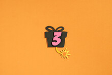 Number Three With Gift Box On Orange Background - Paper Cut Style
