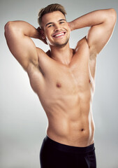 Do these muscles look good on me. Studio portrait of a muscular young man posing against a grey background.