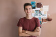 © Alberto Bogo/Stocksy - Smiling Designer In Front Of Colorful Vision Board