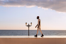 Black Man Standing On Platform Over Sea