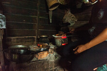 Diverse Female Cooking In Wood-burning Stove In The Kitchen 