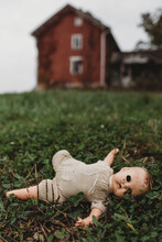 Creepy Baby Doll In The Grass