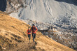 © plpictures by Paedii Luchs/Stocksy - Trail runners and mountain hut in the alps.