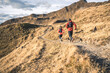 © plpictures by Paedii Luchs/Stocksy - Two runners on a golden trail in the alps.