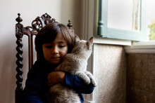 Little Kid Holding Cat Indoor