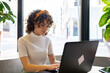 © Luis Velasco/Stocksy - Portrait Of A Businesswoman Sitting In The Office.