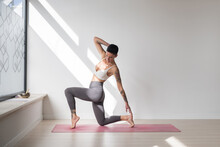 Woman Practising Yoga In Studio 