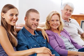 Wall Mural - Our parents is our inspiration. Shot of a happy family sitting together indoors.