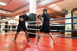 © Javier Díez/Stocksy - Male boxers training on ring