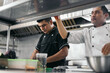 © Pedro Merino/Stocksy - Latin chefs working in professional kitchen
