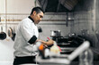 © Pedro Merino/Stocksy - Latin chef cooking in kitchen