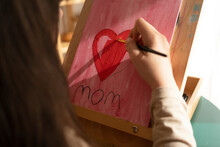 Girl Painting Red Heart To Give To Mom