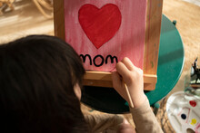 Girl Writing Mom On Picture 