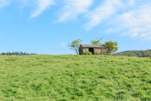 A Small Stone House On A Hill.