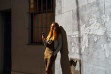 Young Happy Woman Using Phone In The City