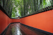 © Heng Yu/Stocksy - Passage between red walls surrounded by bamboos