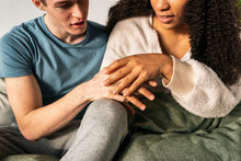 Interracial Couple With Clasped Hands Enjoying Day Off At Home