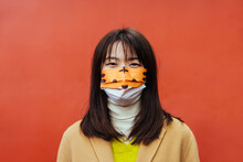 Asian Woman With A Colorful Mask