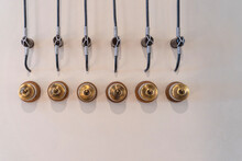 A Row Of The Six Antique Brass Light Switches For Vintage Decorating The Home And Living Interior On The Wall.