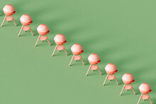 A Row Of Pink Barbeque Grill On A Green Background