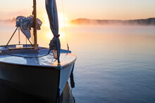 Bow Of Dinghy Sailboat On Freshwater Lake At Sunrise