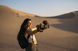 © Pedro Merino/Stocksy - Woman video blogging in the desert